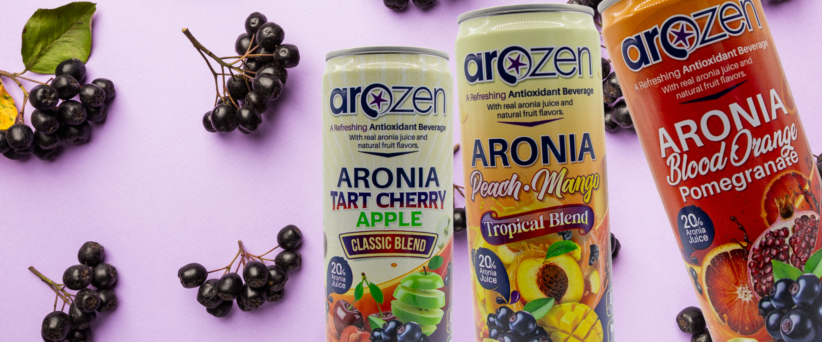 Three Arozen aronia berry drinks on a purple background with black chokeberries.